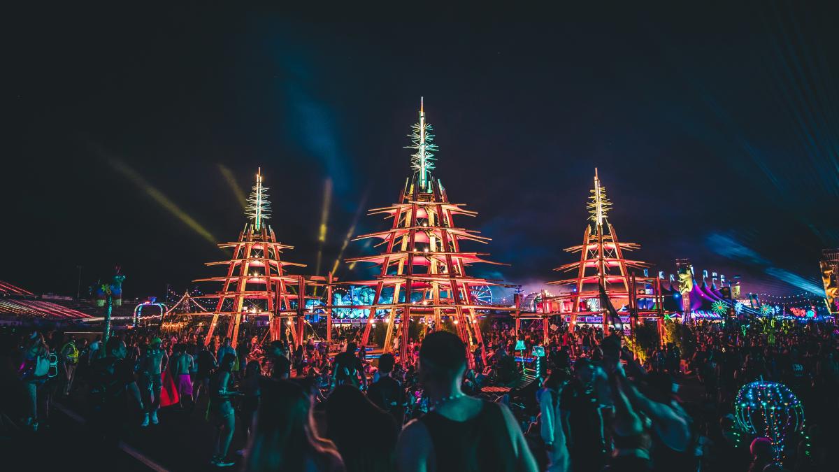 people gathering in front of brown tower during nighttime