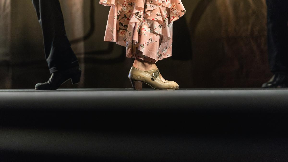 two man and woman standing back to back