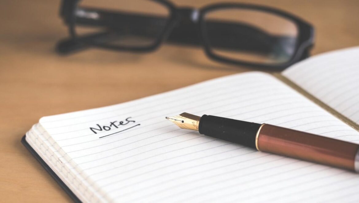brown fountain pen on notebook