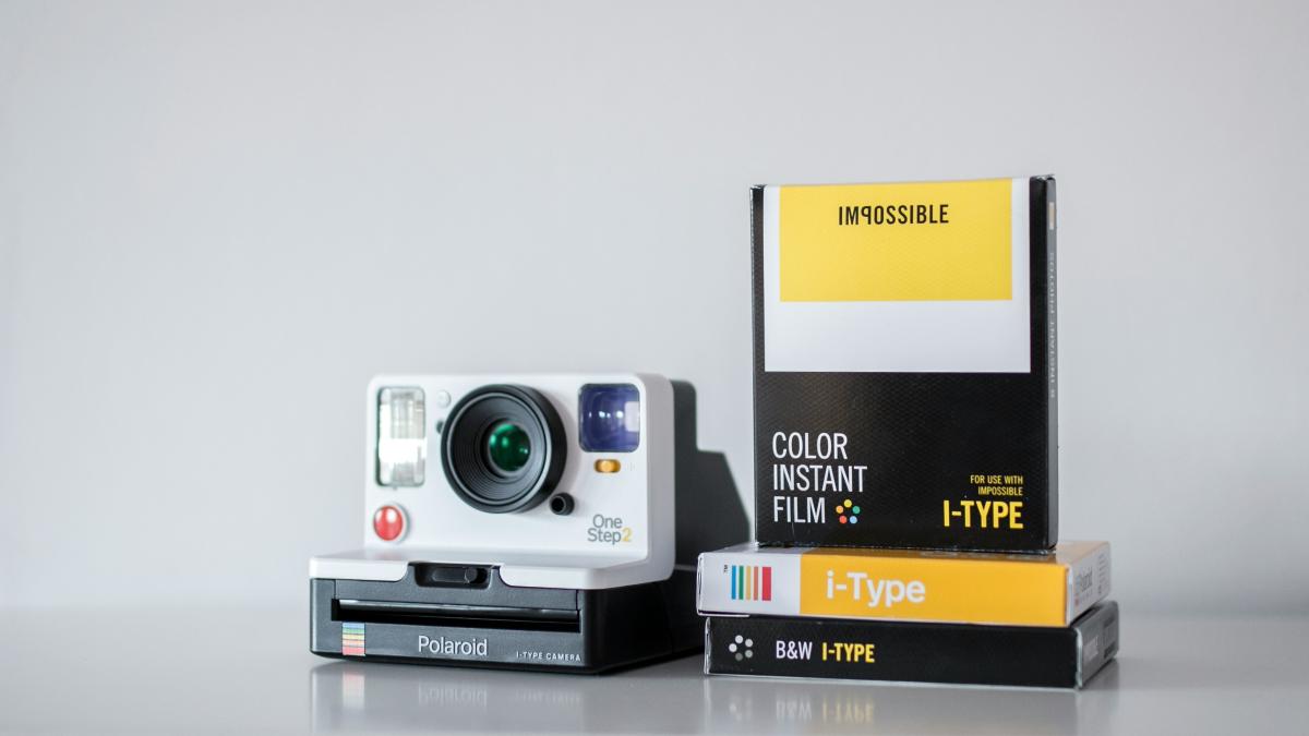 white and black camera with box