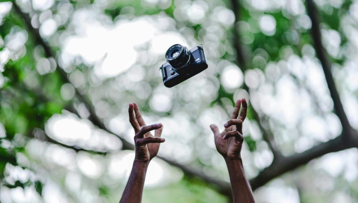 person throwing DSLR camera