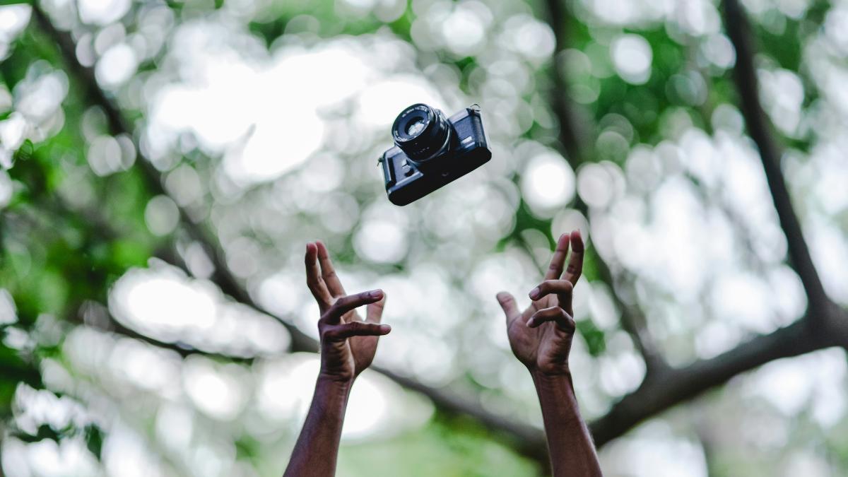 person throwing DSLR camera