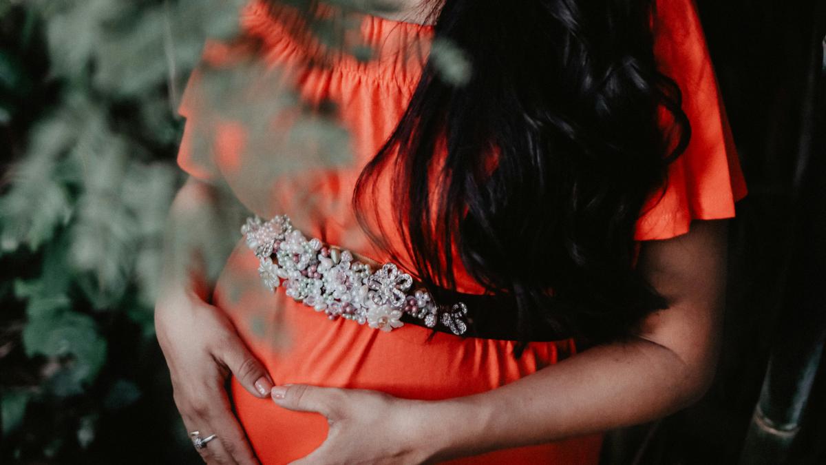 pregnant woman holding her tummy