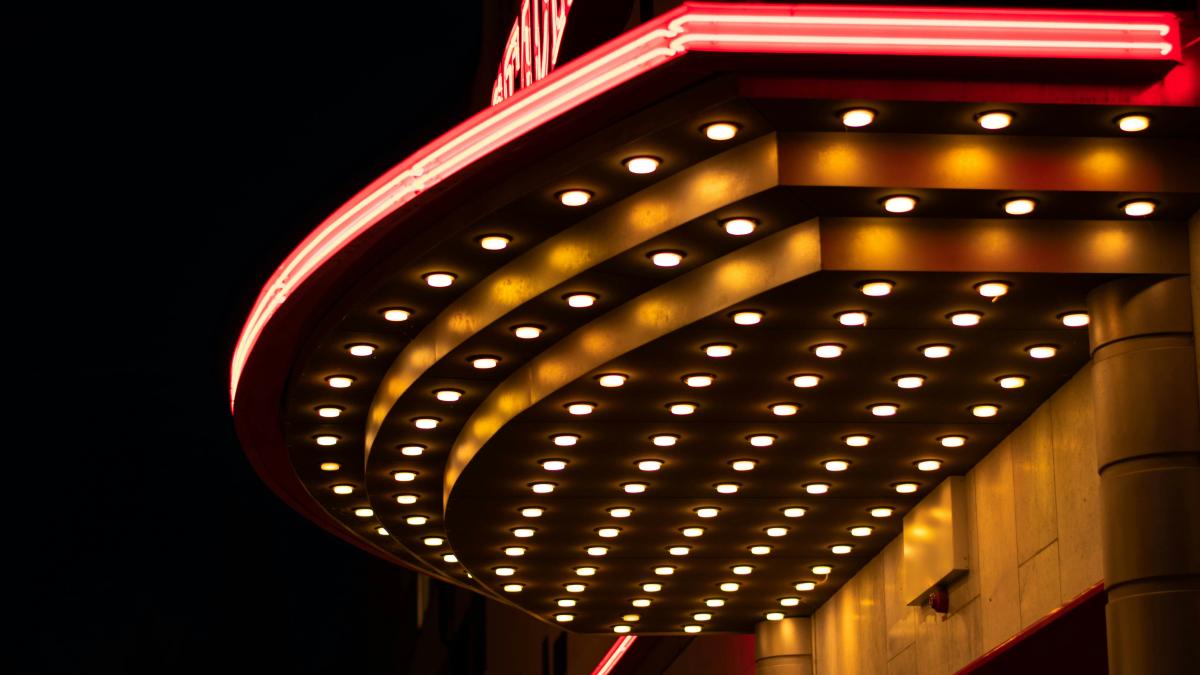 a building with a sign lit up at night