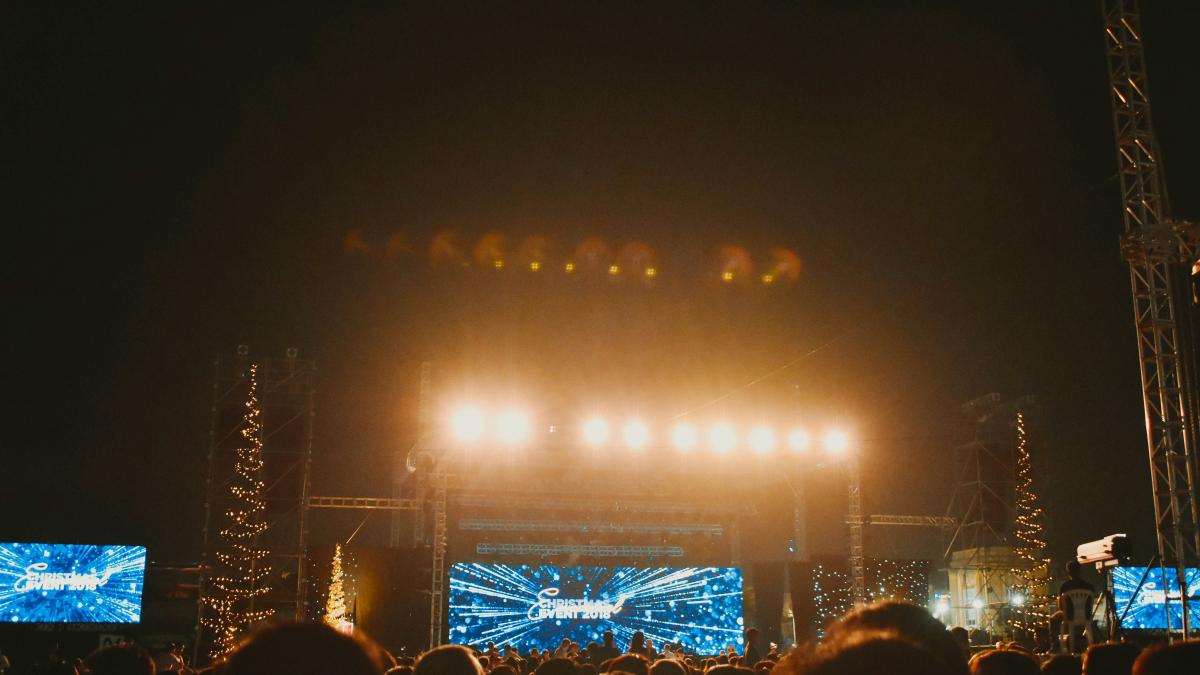 people in front of lighted concert stage