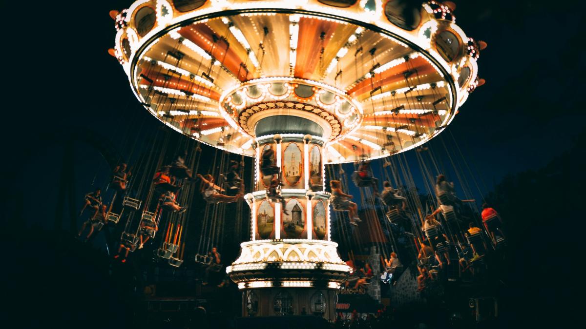 people riding revolving carnival ride during night