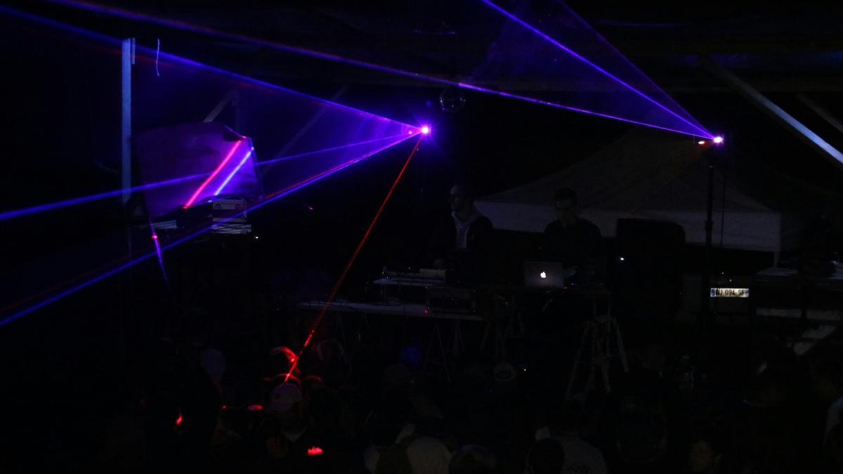 three blue stage lights inside black room