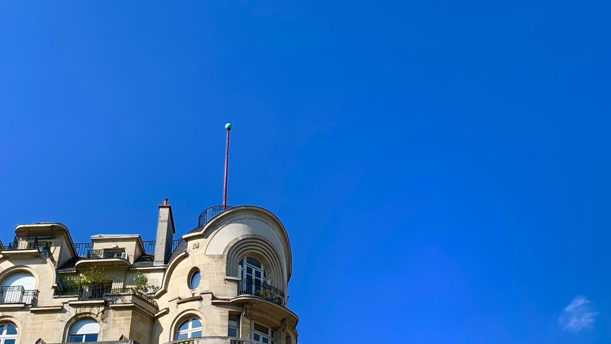 a tall building with a flag on top of it