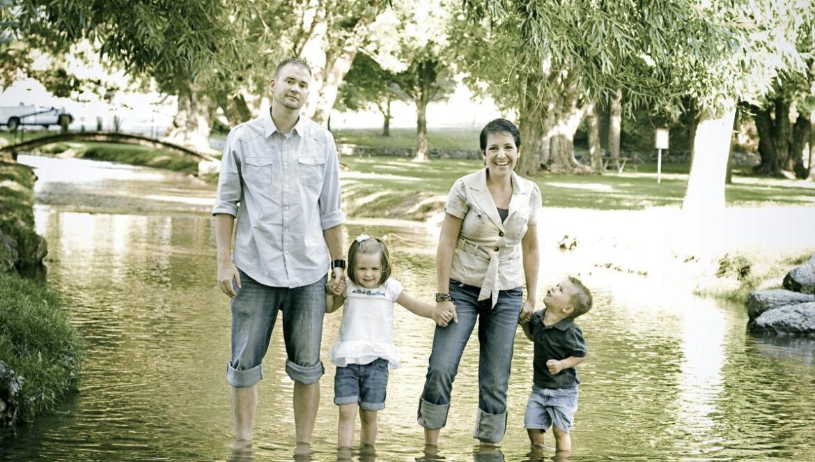 man and woman standing on stream