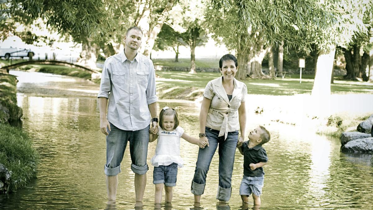 man and woman standing on stream