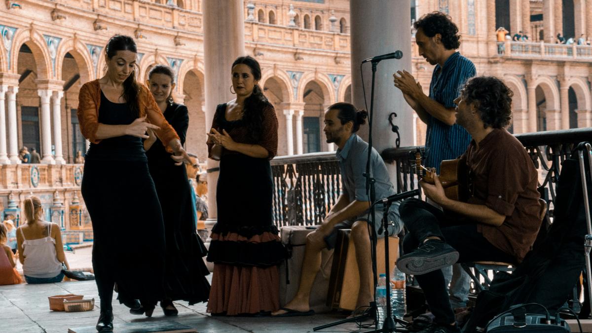 woman in black dress standing beside man in black shirt