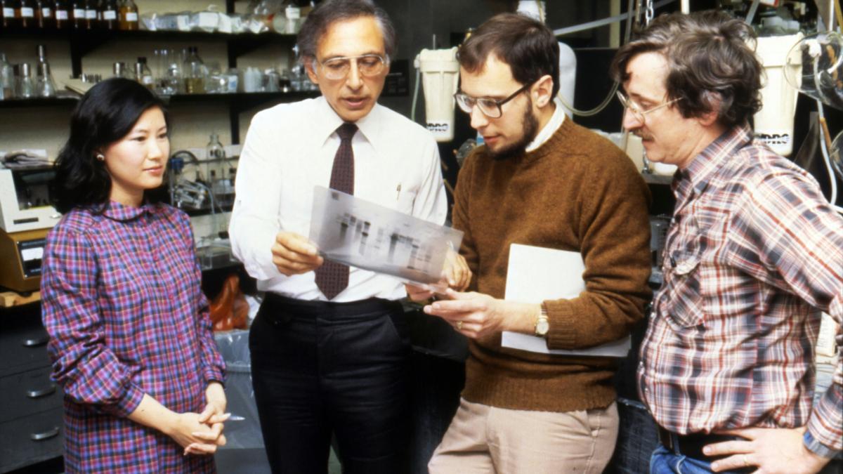 three men standing beside woman