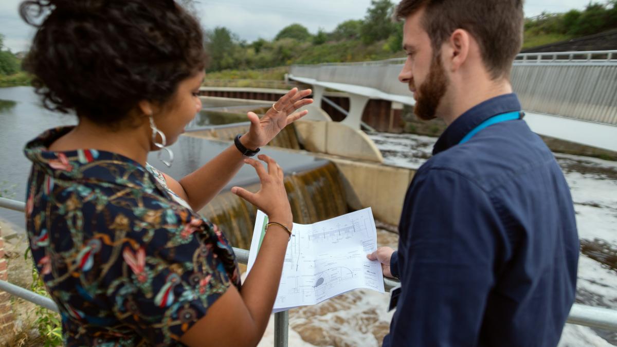man in blue shirt holding white paper