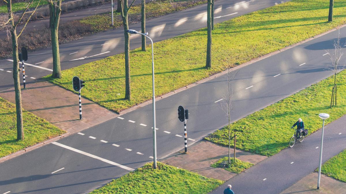 2 men walking on gray concrete road during daytime