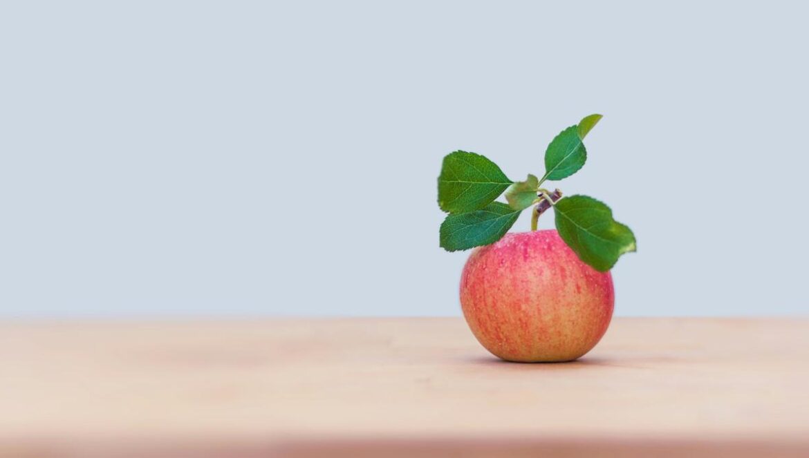 red apple on brown wooden table
