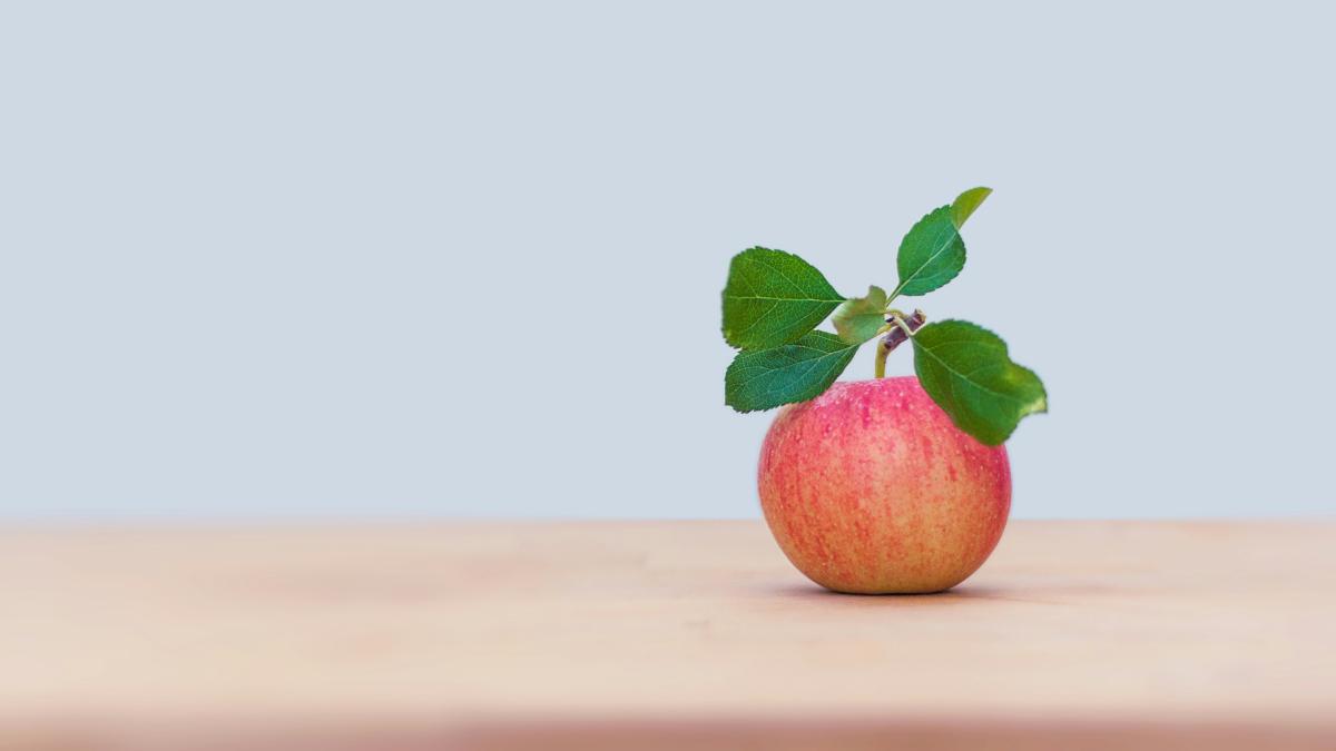 red apple on brown wooden table