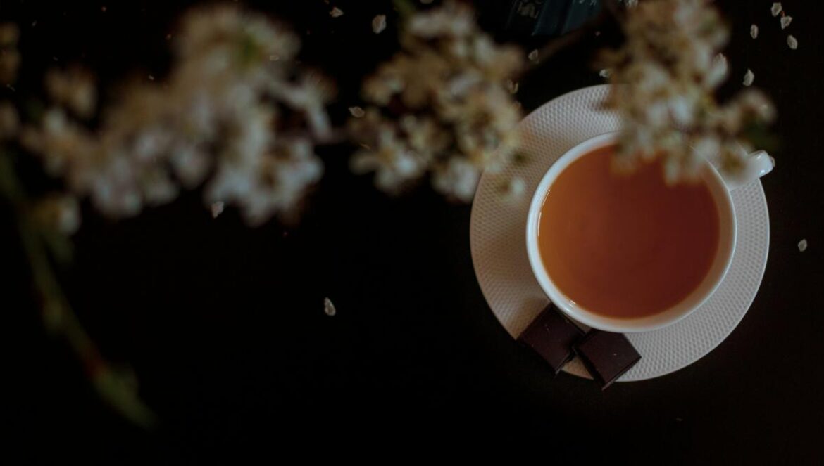 orange and white flower on brown wooden table