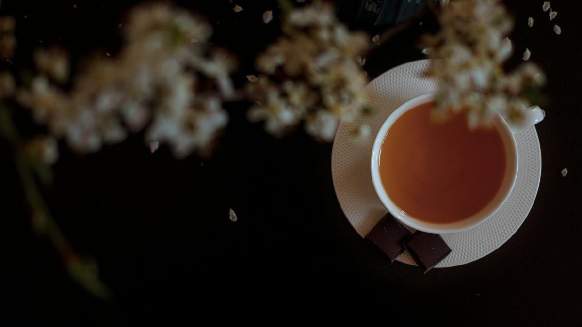 orange and white flower on brown wooden table