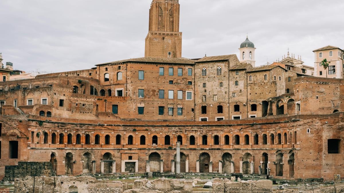 brown concrete building under white clouds during daytime