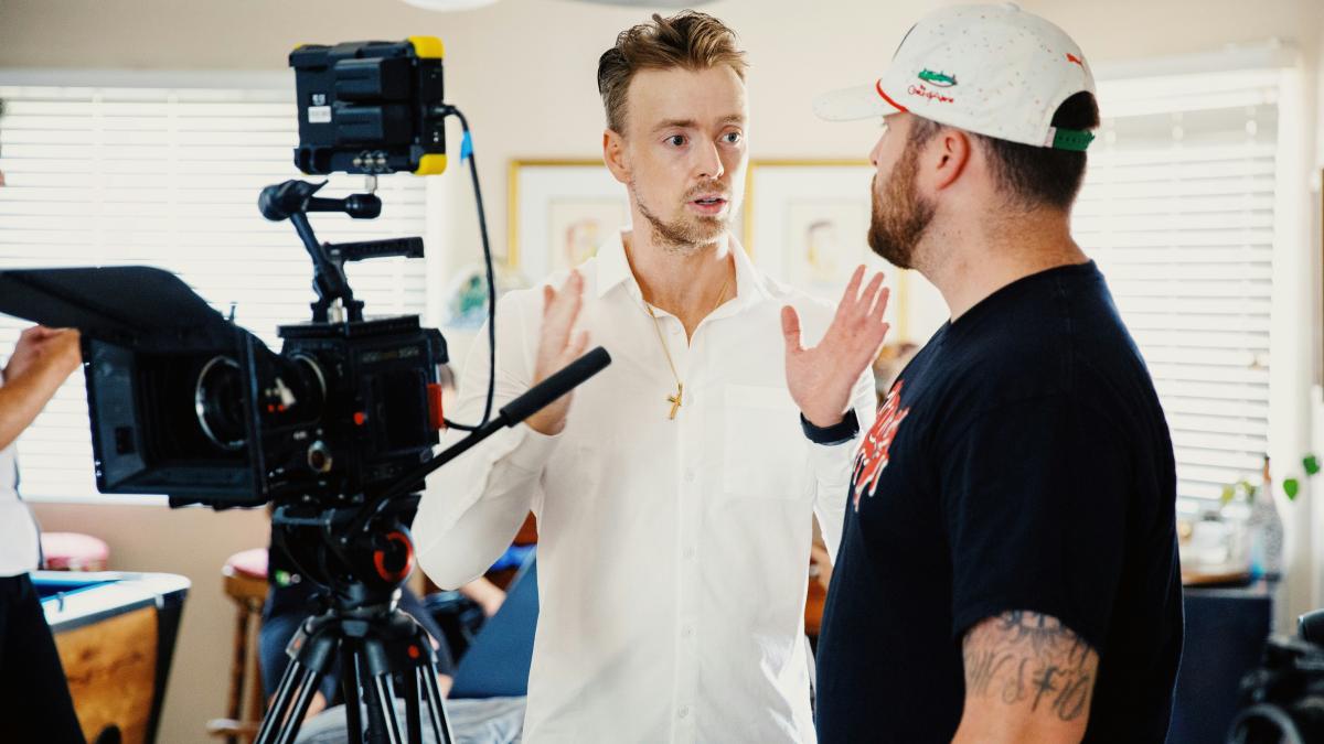 man in black crew neck t-shirt standing beside woman in white button up shirt