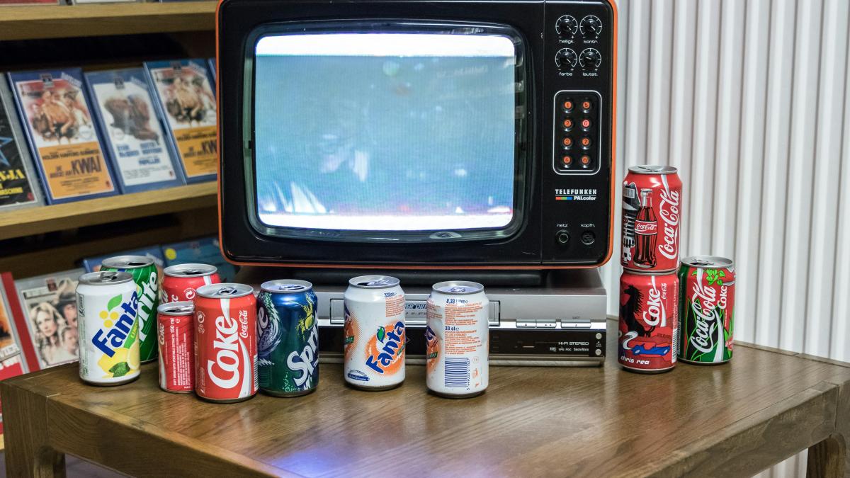 black crt tv turned on beside white plastic bottle