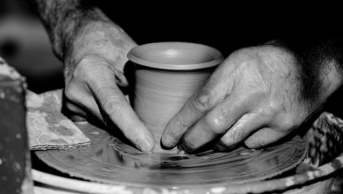 grayscale photo of person holding round plate