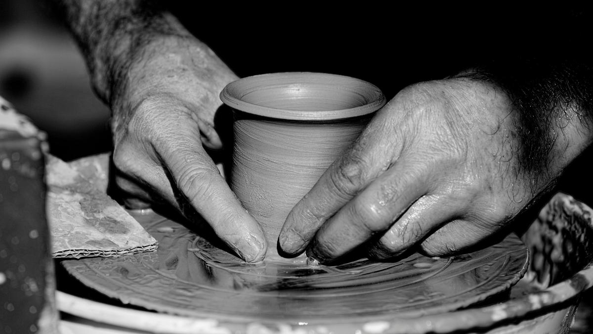 grayscale photo of person holding round plate