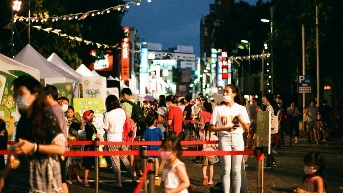 people sitting on chair near road during night time