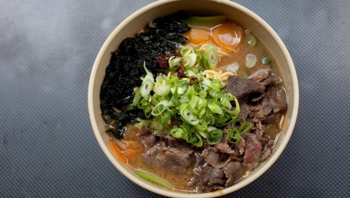 noodle soup with green leaf on white ceramic bowl