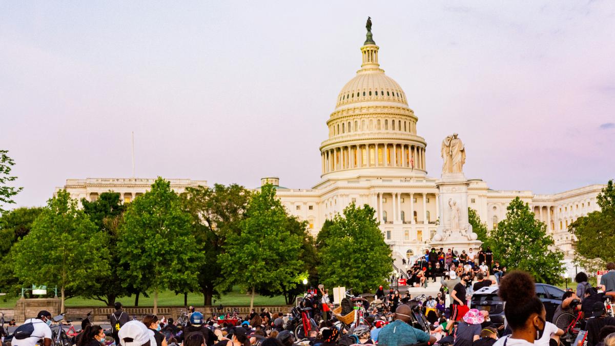 people in front of white concrete building during daytime