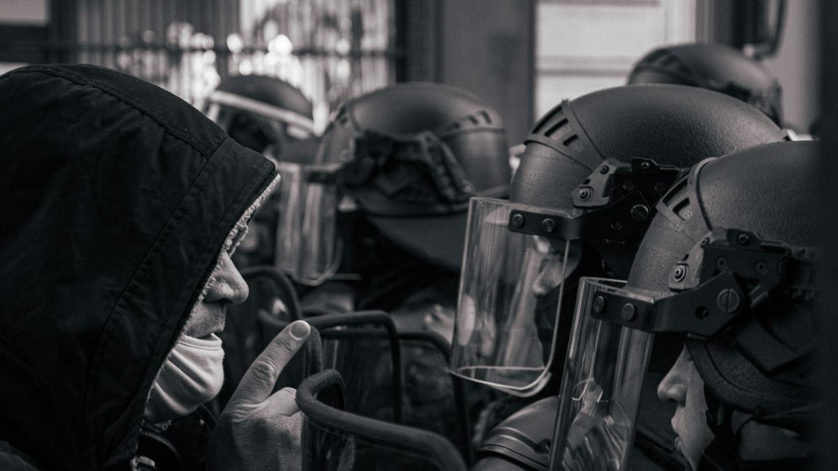 grayscale photo of motorcycle helmet and helmet