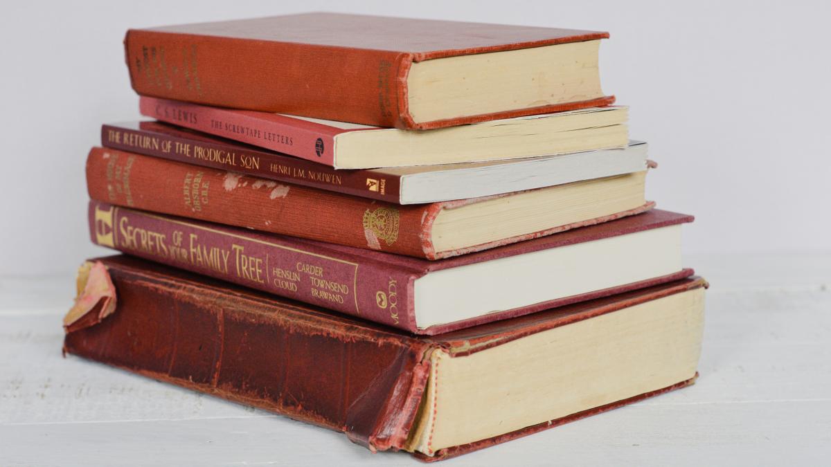brown hardbound books on white table
