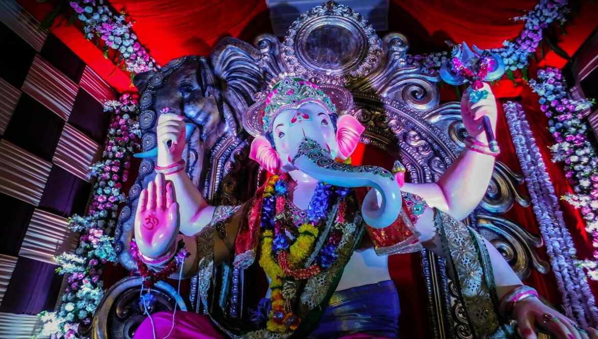 hindu deity statue on red textile