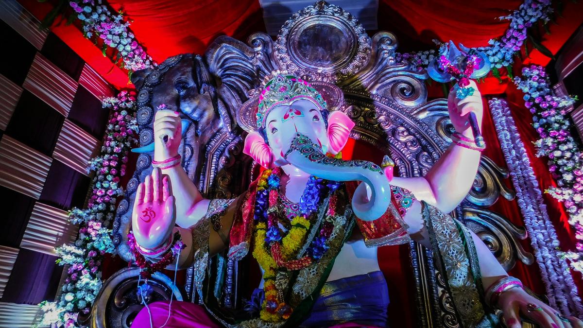 hindu deity statue on red textile