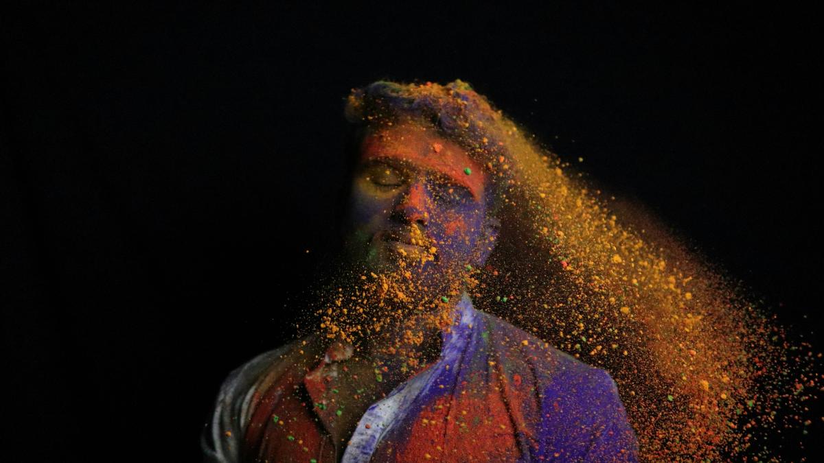 man in black leather jacket smoking
