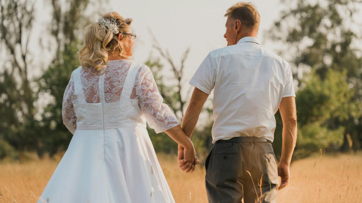 man in white shirt and woman in white dress