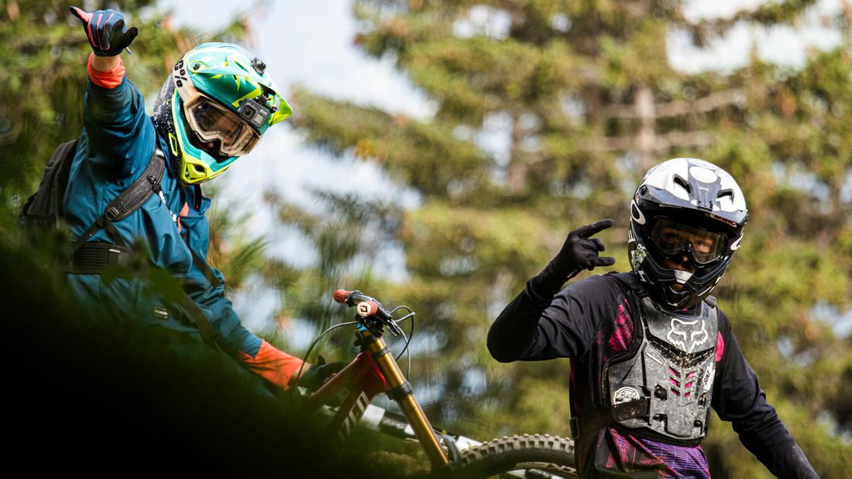 man in green and white jacket riding on orange and black motocross dirt bike