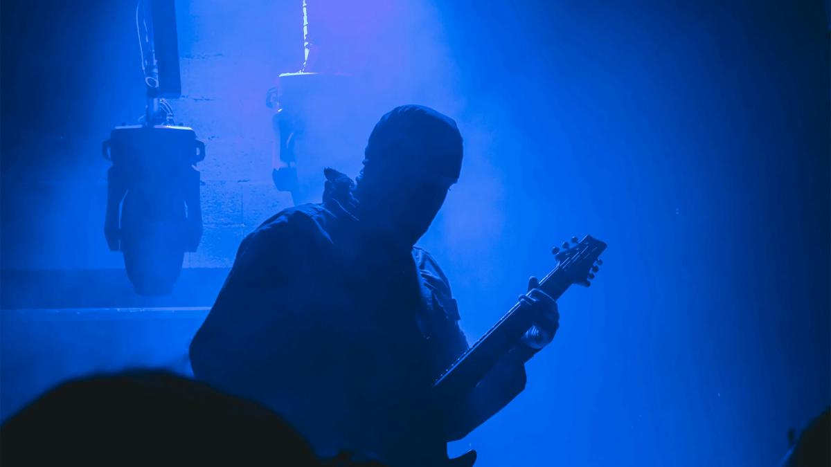 silhouette of man playing guitar