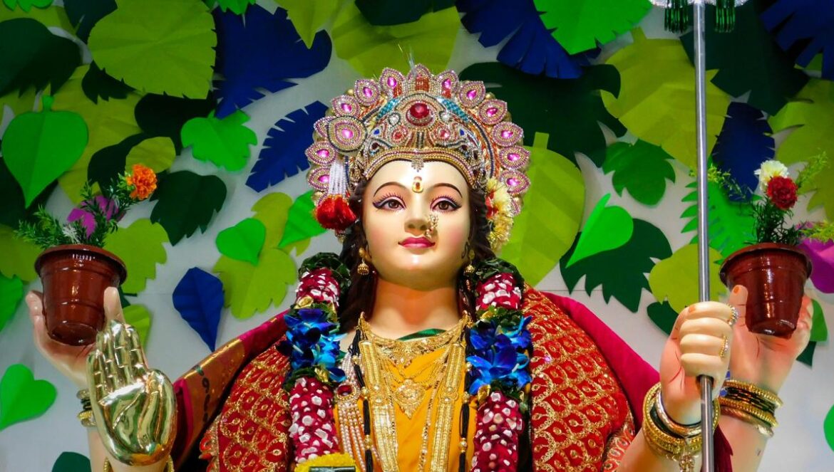 woman in red and gold sari dress