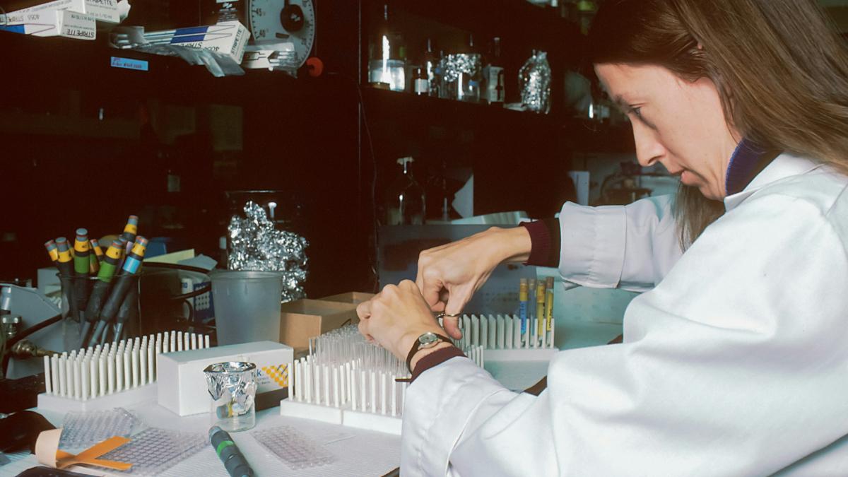 a woman in a lab coat is doing something