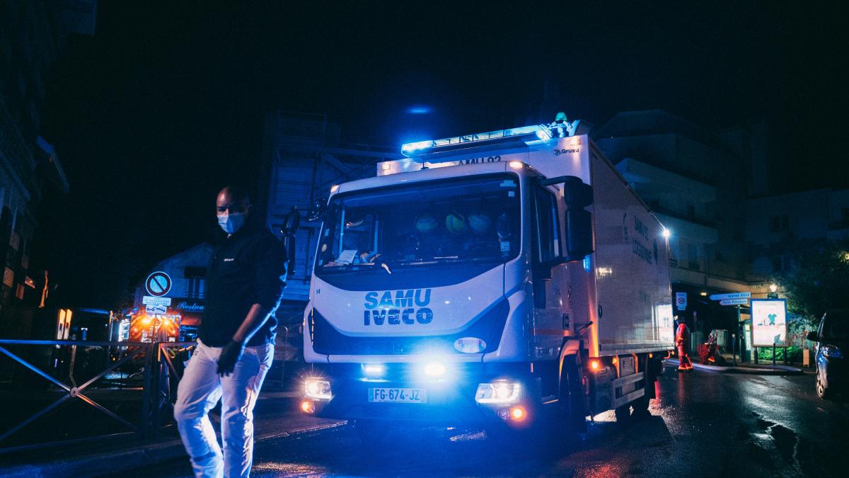 a man standing next to a truck on a street