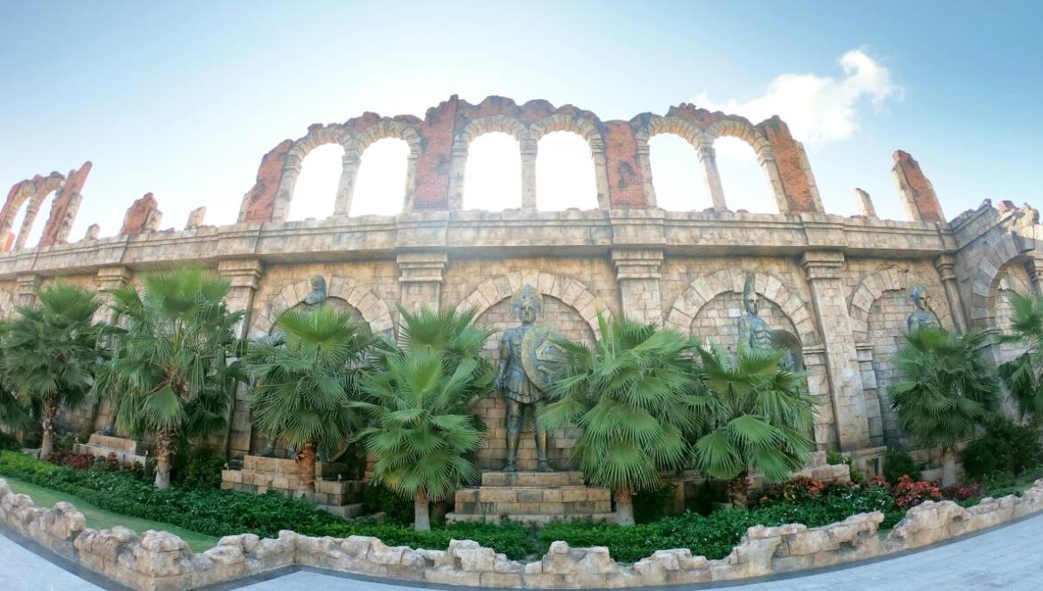 a large building with palm trees in front of it