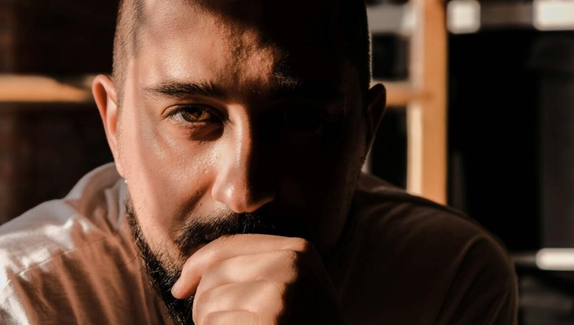 a man with a beard and a white shirt