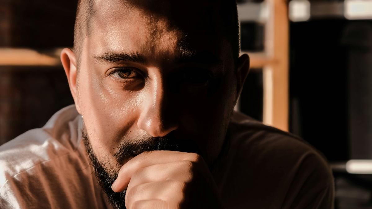 a man with a beard and a white shirt