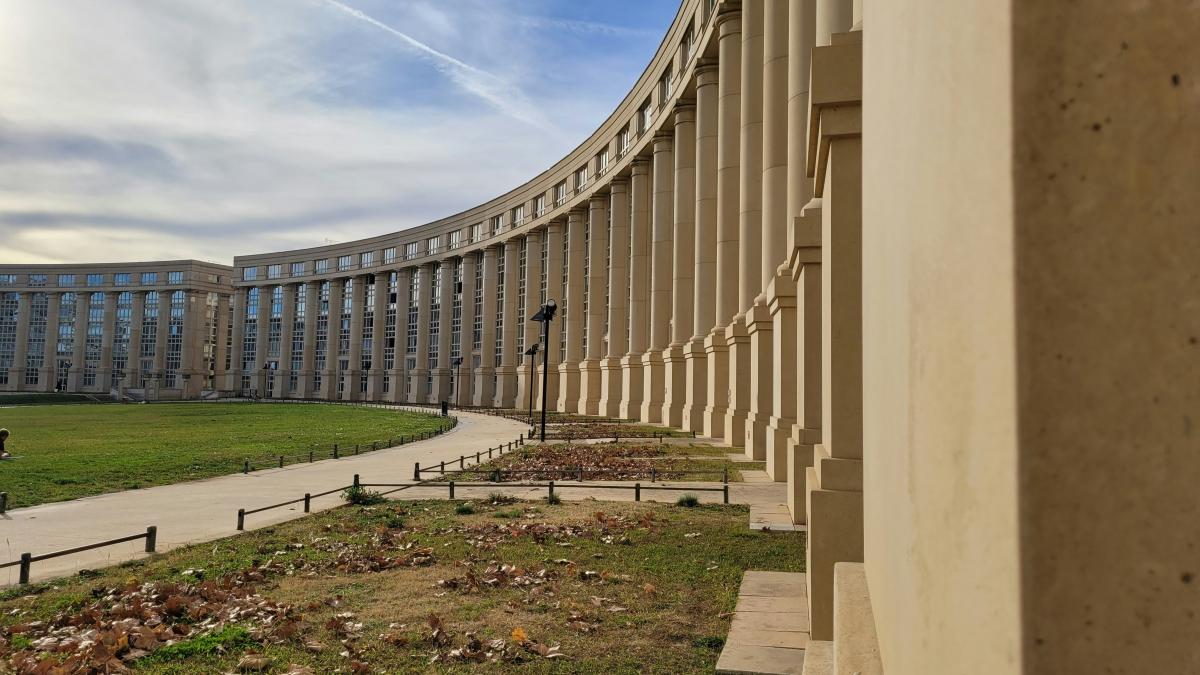 a large building with a curved walkway in front of it