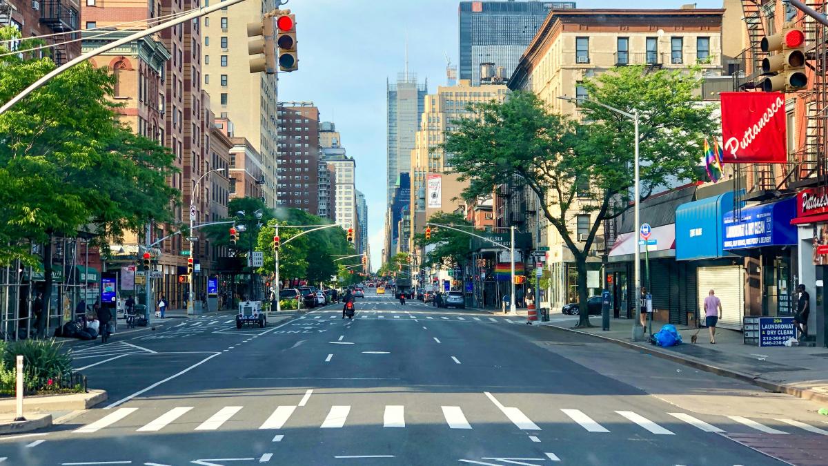 a city street with tall buildings and a traffic light