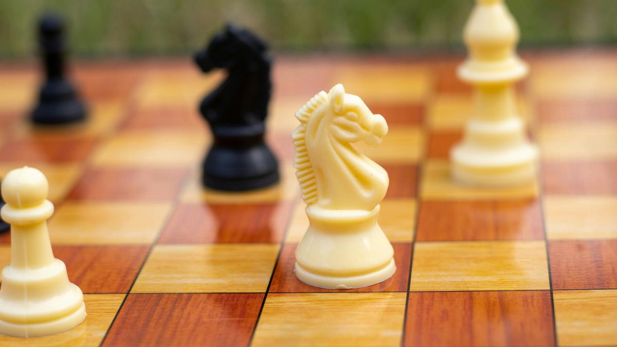a close up of a chess board with pieces on it