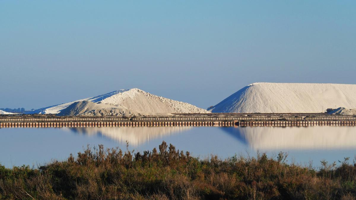 a large body of water surrounded by snow covered mountains