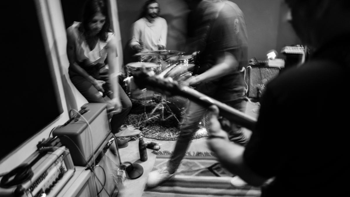 a group of people playing music in a room