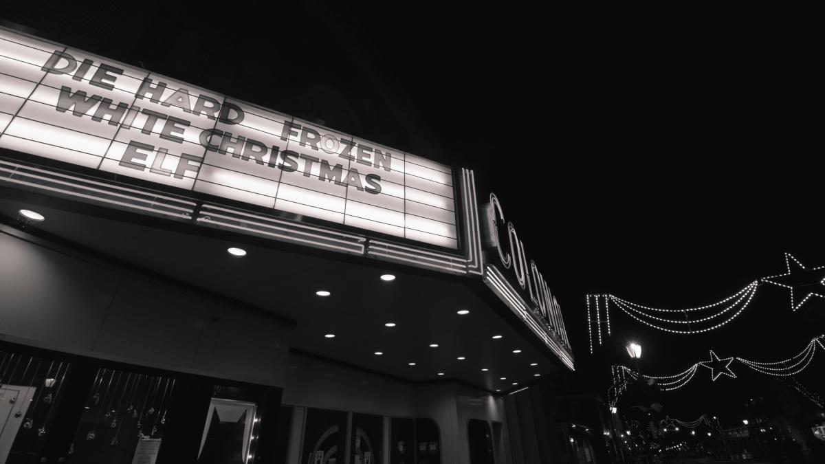 a black and white photo of a theater marquee